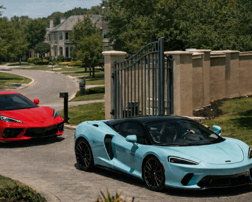 Two luxury exotic rental cars parked in a Dallas neighborhood driveway